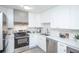 Updated kitchen with white cabinets and stainless steel appliances at 9155 E Center Ave # 4B, Denver, CO 80247