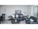 Living room features a comfy sofa and access to the dining area at 9155 E Center Ave # 4B, Denver, CO 80247