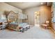 Main bedroom with a four-poster canopy bed and sitting area at 9983 Heather Dr, Castle Rock, CO 80108