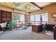 Bright home office with stained glass ceiling, large windows, and custom wood desk at 9983 Heather Dr, Castle Rock, CO 80108