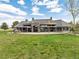 Back exterior of house with large backyard, patio, and landscaping at 9983 Heather Dr, Castle Rock, CO 80108