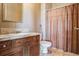 Simple bathroom with shower/tub combo, toilet, and a vanity with storage at 9983 Heather Dr, Castle Rock, CO 80108