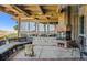 Covered patio with fireplace and comfortable seating at 9983 Heather Dr, Castle Rock, CO 80108