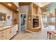Elegant bathroom with a corner fireplace, built in cabinetry, and a view into another room at 9983 Heather Dr, Castle Rock, CO 80108