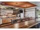 Rustic kitchen with light wood cabinets, granite countertops, and a breakfast bar at 9983 Heather Dr, Castle Rock, CO 80108