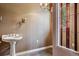 Small powder room with pedestal sink and stained glass window at 9983 Heather Dr, Castle Rock, CO 80108