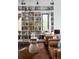 Living room with built-in bookshelves and leather armchairs at 3823 Castle Butte, Castle Rock, CO 80109