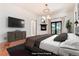 Virtually staged main bedroom with a fireplace and access to a deck at 3823 Castle Butte, Castle Rock, CO 80109