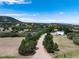 Aerial view of a long driveway leading to a modern home in a scenic setting at 3823 Castle Butte, Castle Rock, CO 80109