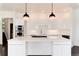 Modern white kitchen with large island and stainless steel appliances at 3823 Castle Butte, Castle Rock, CO 80109