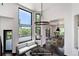Virtually staged living area with a view of the deck and surrounding trees at 3823 Castle Butte, Castle Rock, CO 80109
