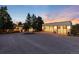 Detached modern garage with large glass doors and outdoor lighting at dusk at 3823 Castle Butte, Castle Rock, CO 80109