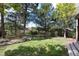 Landscaped backyard with mature trees at 3823 Castle Butte, Castle Rock, CO 80109
