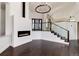 Spacious living room with a modern fireplace and staircase at 3823 Castle Butte, Castle Rock, CO 80109