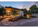 Modern home's front yard with a stone pathway, landscaping, and outdoor lighting at 3823 Castle Butte, Castle Rock, CO 80109