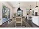 Modern dining room, virtually staged, with a wood table and dark hardwood floors at 3823 Castle Butte, Castle Rock, CO 80109