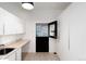 Laundry room with sink, cabinets, and exterior access at 3823 Castle Butte, Castle Rock, CO 80109