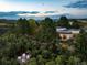 Aerial view of a modern home with a detached garage, showcasing expansive views and landscaping at 3823 Castle Butte, Castle Rock, CO 80109