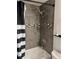 Shower/tub with gray tile surround and built-in shower caddy at 1350 Josephine St # 403, Denver, CO 80206