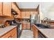 Eat-in kitchen featuring stainless steel appliances and a farmhouse sink at 22933 E Ontario Dr # 105, Aurora, CO 80016