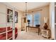 Home office or study with a desk, red leather chair, and stylish chandelier at 10916 Towerbridge Rd, Highlands Ranch, CO 80130