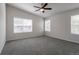 Spacious bedroom with neutral carpeting, ceiling fan, and two windows with blinds at 2381 N Elmira St, Aurora, CO 80010