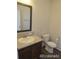 Clean bathroom with single vanity, toilet, and a framed mirror at 2381 N Elmira St, Aurora, CO 80010