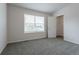 Bright bedroom with window, closet, and neutral grey carpet at 2381 N Elmira St, Aurora, CO 80010