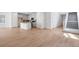 Open living room and kitchen with light wood floors at 13521 E 99Th Pl, Commerce City, CO 80022