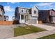 Two-story house with gray siding, a gray door, and a two-car garage at 13521 E 99Th Pl, Commerce City, CO 80022