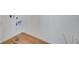 Convenient laundry area with wood-look flooring and built-in cabinetry at 13521 E 99Th Pl, Commerce City, CO 80022