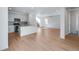 Open concept kitchen and living area with island and hardwood floors at 13521 E 99Th Pl, Commerce City, CO 80022