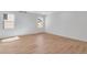 Bright bedroom with light wood floors and a window at 13521 E 99Th Pl, Commerce City, CO 80022