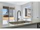 Kitchen sink and faucet with a view of the backyard at 13521 E 99Th Pl, Commerce City, CO 80022