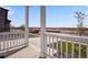 Front porch view of a house with white railings overlooking a residential street at 13521 E 99Th Pl, Commerce City, CO 80022