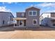 Grey two-story home with a backyard and patio at 13521 E 99Th Pl, Commerce City, CO 80022
