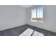 Spacious bedroom featuring grey carpet and a large window with a view at 13521 E 99Th Pl, Commerce City, CO 80022