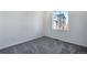 Bright bedroom with carpet flooring and a window at 13521 E 99Th Pl, Commerce City, CO 80022