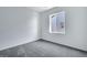Bright bedroom with grey carpet and a window offering a view at 13521 E 99Th Pl, Commerce City, CO 80022