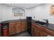 Basement wet bar with dark wood cabinets and granite countertop at 1027 Southbury Pl, Highlands Ranch, CO 80129