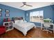 Blue-walled bedroom with hardwood floors and large window at 1027 Southbury Pl, Highlands Ranch, CO 80129