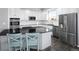 Modern kitchen with stainless steel appliances and a large island at 1027 Southbury Pl, Highlands Ranch, CO 80129