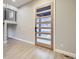 Light and airy entryway with wood door and laminate flooring at 1670 Simms St, Lakewood, CO 80215