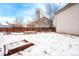 Backyard with raised garden beds covered in snow at 6273 Sparrow Cir, Firestone, CO 80504