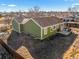 Green house exterior with back patio, showing house and yard details at 9504 Milwaukee Ct, Thornton, CO 80229