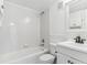 White bathroom with tile shower and white vanity at 1648 S Cole St # B7, Lakewood, CO 80228
