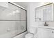 Bathroom with glass shower doors, white vanity, and tile flooring at 1648 S Cole St # B7, Lakewood, CO 80228