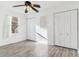 Bedroom with wood-look laminate floors, white closet doors, and ceiling fan at 1648 S Cole St # B7, Lakewood, CO 80228