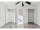 Large bedroom with wood-look laminate floors, double closets, and a ceiling fan at 1648 S Cole St # B7, Lakewood, CO 80228