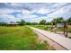 Paved trail in a grassy park with signage and picnic area at 1648 S Cole St # B7, Lakewood, CO 80228